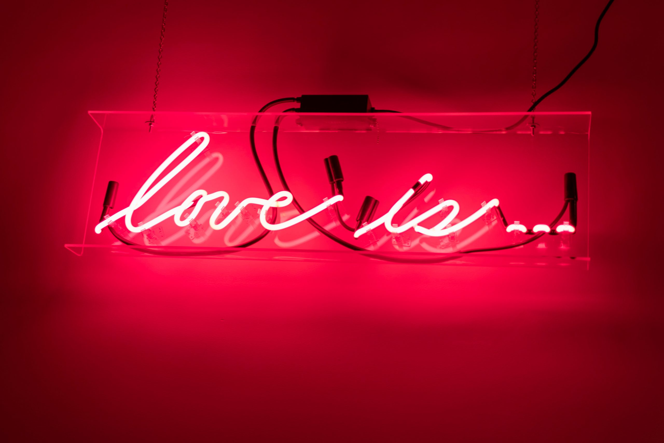 "love is" neon sign